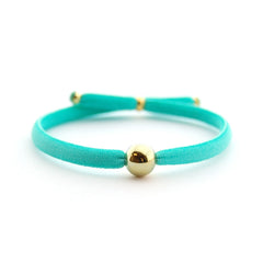 INDA - pulsera bolita dorada flúor